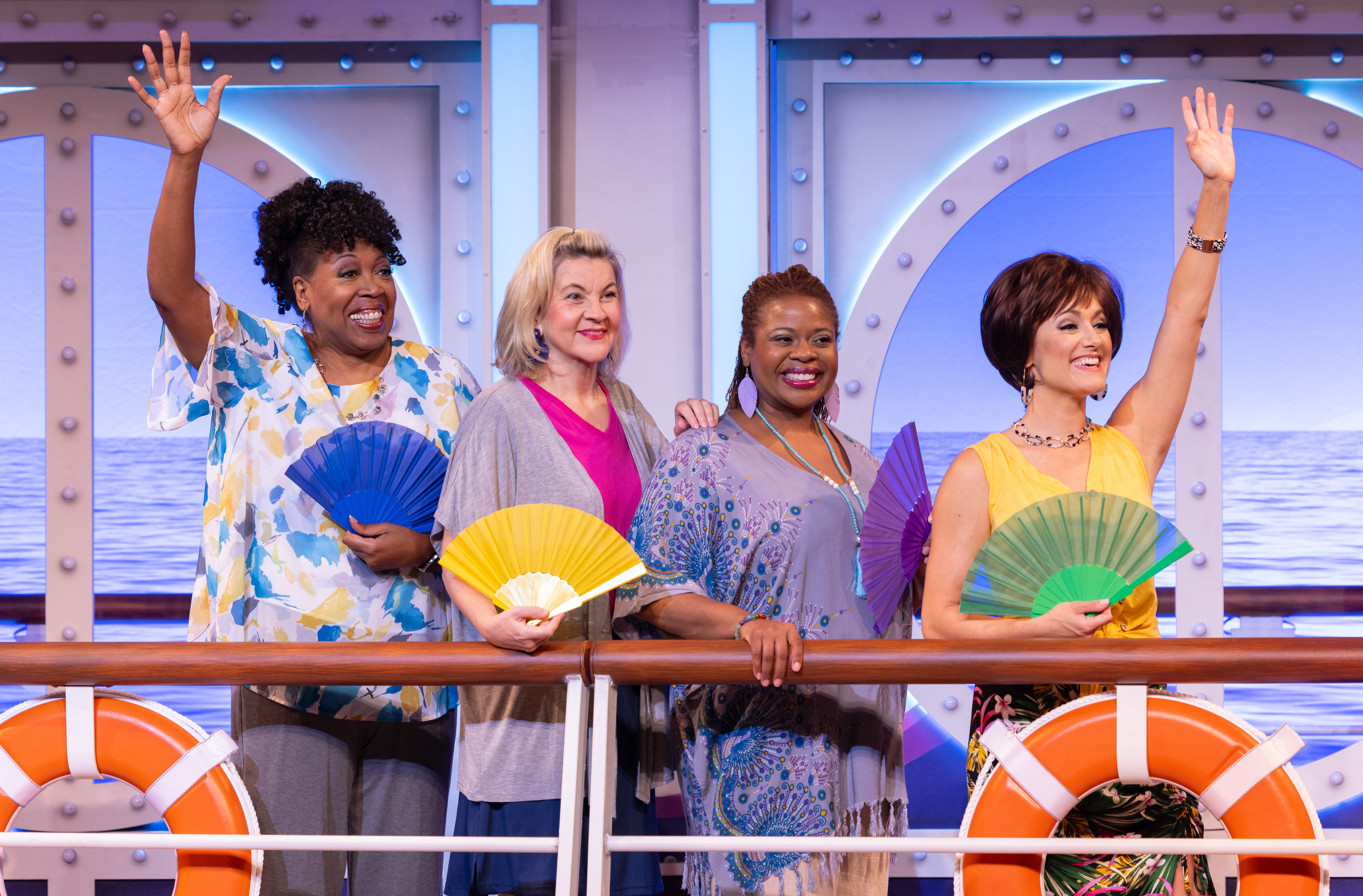 Four women standing on the deck of a cruise ship